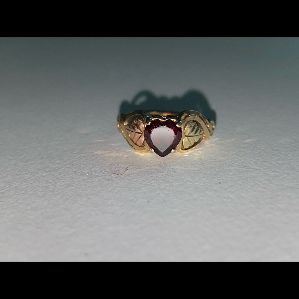 Gold ring with red heart
